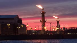 Flame beam on Rostral columns for the opening tourist season in St Petersburg, Russia