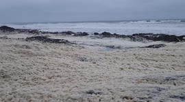 Stormy Conditions Whip Up Sea Foam in Cork Ireland with Yellow Weather Warning in Place