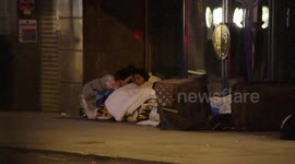Rough Sleepers Settle By Posh Upmarket Mayfair Shop Front Door