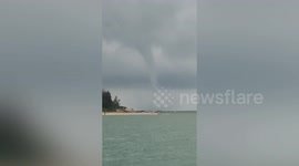 Tourists flee as tornado swirls over beach in southern China