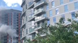 Fire tears through an apartment block in London - as 125 firefighters tackle the blaze
