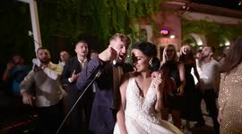 wedding vibes. dacing couple ,groom singing.outdor wedding.peoples having fun