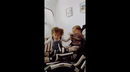 Big sister dancing with her baby brothers. Twins catching her hair