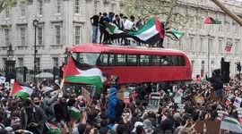 Protesters unfurl massive Palestine flag on top of double decker bus outside Downing Street