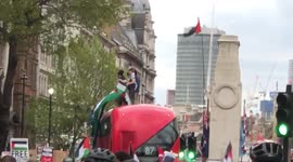 The moment Free Palestine protesters climb on top of a London bus outside Downing Street