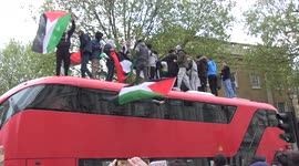 Pro-Palestine protesters climb on top of double decker bus at central London protest