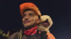 Pet dog enjoys view while riding on cyclist owner’s shoulders