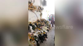 Pet lovers lay flowers at site where dog was shot dead by policemen in China