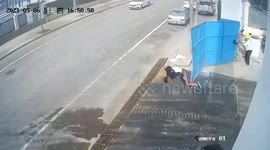 Pedestrian knocked over by iron gate blown open by wind in China