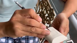 Vietnamese man sculpting beautiful 3D flower on the soap