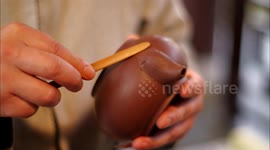 Chinese craftsman meticulously moulds Yixing clay teapot