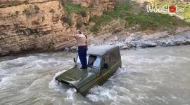 Driver has to be rescued after attempting to navigate through river crossing in Uzbekistan