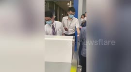 Flight attendant in China hands out cash to passengers as compensation for delayed flight