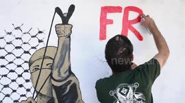'Free Palestine!' Greek street artist spray paints a mural to support Palestinians