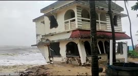 Storm surge topples a house on the coast of Kerala in southern India