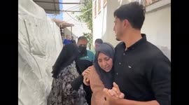 Destructions and a grieving woman in Gaza