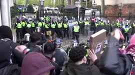 Free Palestine protester is hitting police officer with a flag