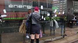 Girl Attempts to rip anti lockdown/anti vax stickers off bus shelter. During Manchester anti lockdown protest