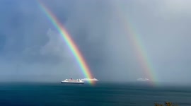 Incredibly bright rainbow lands right in front of Cunard's two magnificent ships