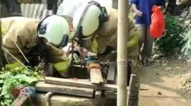 Fire Team Evacuation Cats Entering Wells in East Jakarta, Indonesia