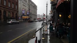 Girlfriend Keeps Boyfriend Dry As Heavy Rain Hits Whitehall In London