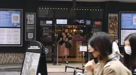Londoners queue up despite downpour as famed West End reopens