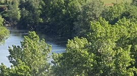 Helicopter uses water from the 'Pisuerga rIver to out a fire in Simancas, Spain
