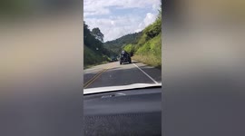 Daredevil clings to the back of moving car in Costa Rica