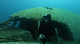Watch this diver explore sunken wreckage of a Hercules transporter plane