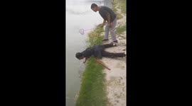 Chinese men catch turtles and fish released into river by tourists and sell them