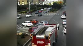Cars waiting at red light drive to side of road to give way to fire engines