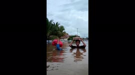 Indonesians keep laughing despite badly flooded streets reaching neck level