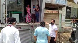 Police officials raid stores operating amid lockdown in central India