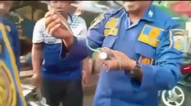 Indonesian firefighters remove tiny snake from motorscooter