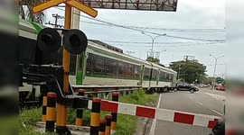 Train almost hits a car that was crossing the railroad in Indonesia
