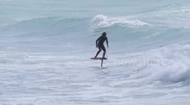 Cornwall tourism in full swing as Hydro foil blade surfers enjoy the waves at Crantock beach in Cornwall UK