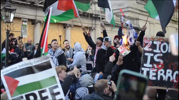 Israel flag burned by pro-Palestine protesters outside Israeli Embassy, London.