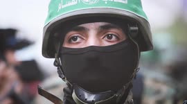 Members of Hamas' military wing march to mark end of hostilities