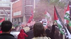 Free Palestine Protesters Set Off Flares As The March Down Market Street In Manchester City Centre
