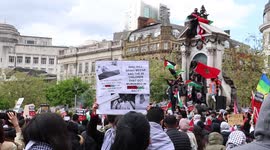 Free Palestine Protester Climbs On The Queen Victoria Statue In Piccadilly Gardens, Manchester. Whilst The Crowd Chants & Light Flares