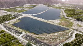 Solar panels farm aerial view from drone shot while sun setting