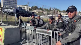 Israeli security forces stand guard near the Israeli Police checkpoint