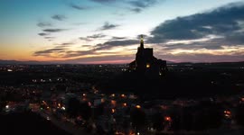 Aerial drone view of Monteagudo Christ castle at night against sunset and  the cityscape of Murcia in Spain.