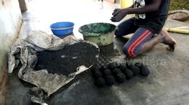 A child creates charcoal in Kampala, Uganda