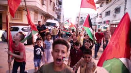 Palestinian Children hold candles at the site of a house that was destroyed by Israeli air strikes