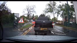 Temporary traffic lights. A lorry and car go straight through a red light