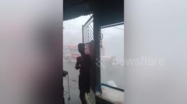 Torrential rain batters market in the Philippines