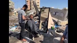 Barber sets up shop in rubble of Gaza as territory counts cost of conflict