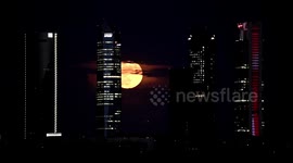 Spectacular Full Flower Supermoon sparkles Spain skyline behind Madrid skyscrapers