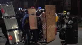 Lasers and makeshift shields used as protesters clash with police in Colombian capital